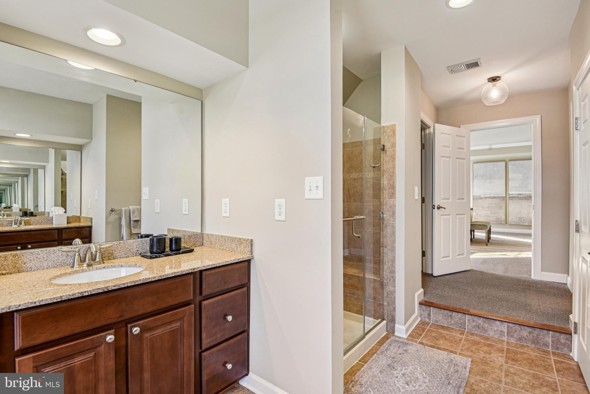 1705 Wolcott Way Hanover, MD 21076 - Photo 43 of 67 a bathroom with a double vanity sink mirror and shower