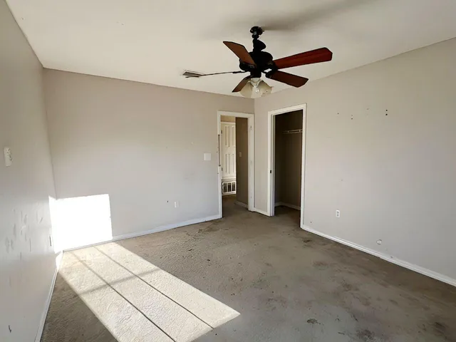 a view of a big room with wooden floor and closet in a kitchen