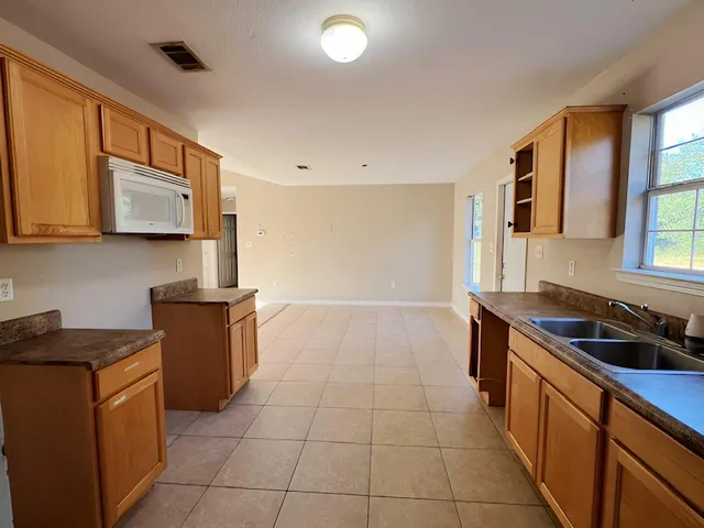 a kitchen with a sink a stove and cabinets