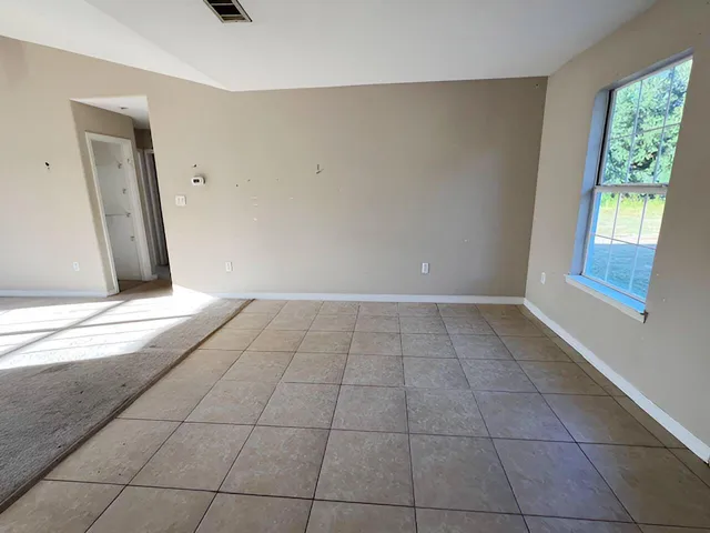 a view of an empty room and window