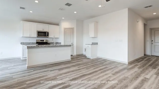 a kitchen with granite countertop a sink and a stove top oven