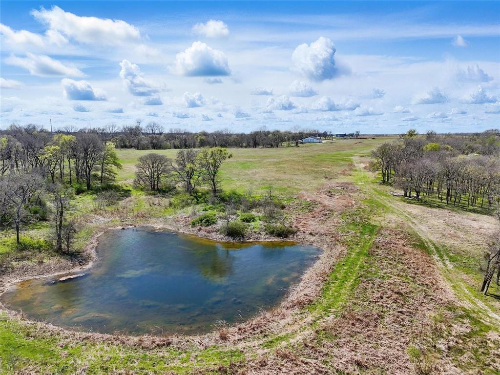 254 North Cooke Road Ennis, TX 75119 - Photo 2 of 8 a view of a lake with outdoor space