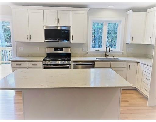 8 Littleton Road Ayer, MA 01432 - Photo 3 of 17 a kitchen with stainless steel appliances a stove a sink and a microwave