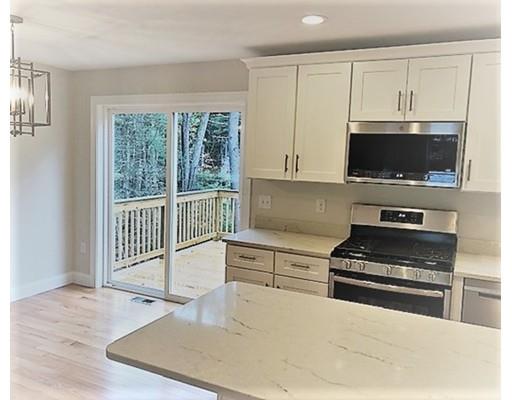 8 Littleton Road Ayer, MA 01432 - Photo 4 of 17 a kitchen with stainless steel appliances a stove a sink and a microwave