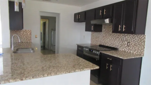 a kitchen with a sink and a refrigerator