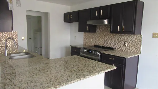 a kitchen with a sink and cabinets