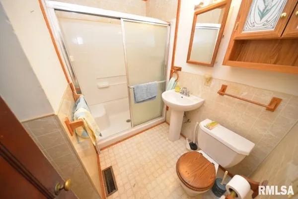 a bathroom with a sink a toilet and a shower