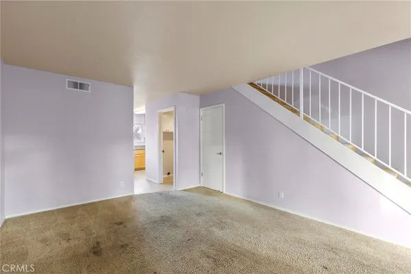 a view of an empty room with stairs