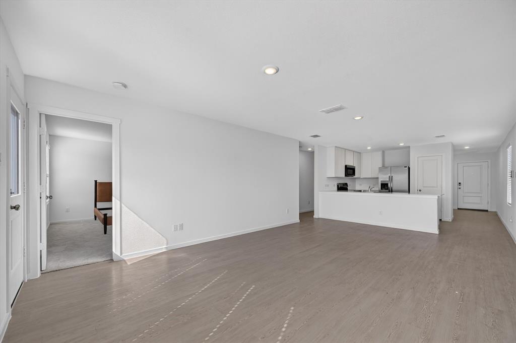 Open-concept living space featuring wood-finish flooring and recessed lighting