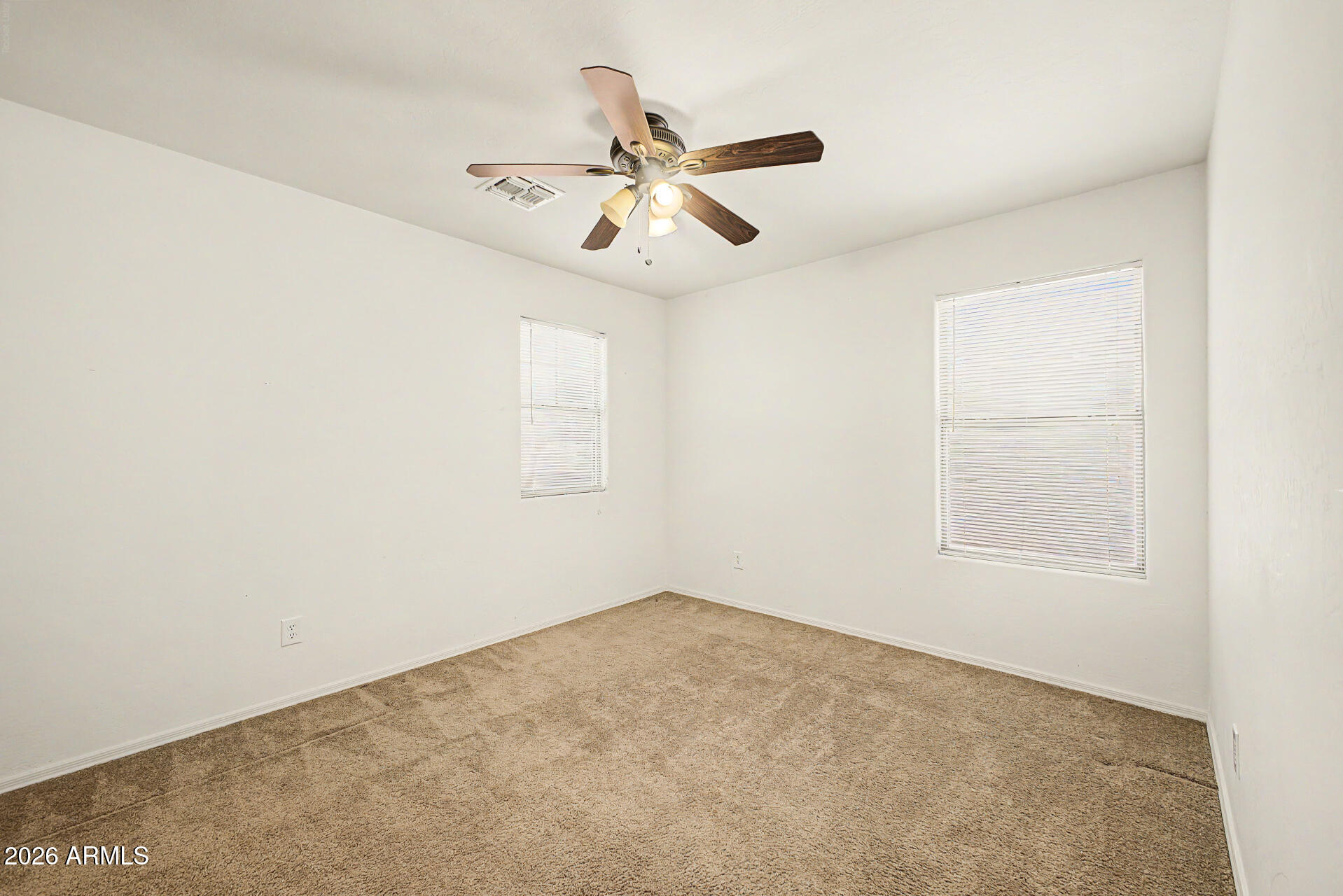 6622 West Harwell Road Laveen, AZ 85339 - Photo 27 of 32 an empty room with a window and a ceiling fan