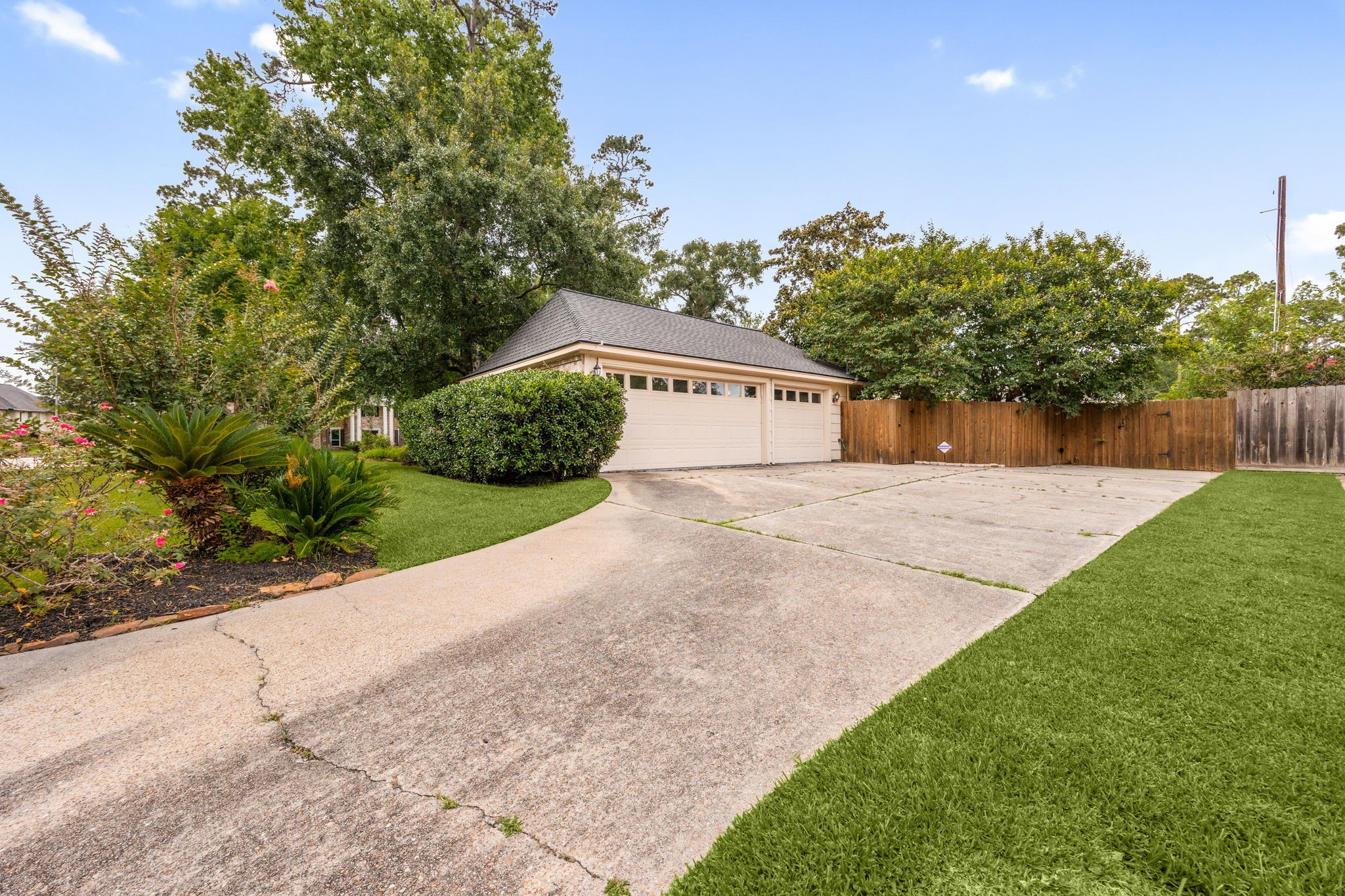 6623 Ampton Drive Spring, TX 77379 - Photo 43 of 45 Three car garage with extra parking. Also, inside it has a workshop area, built in frig, and epoxy floor.