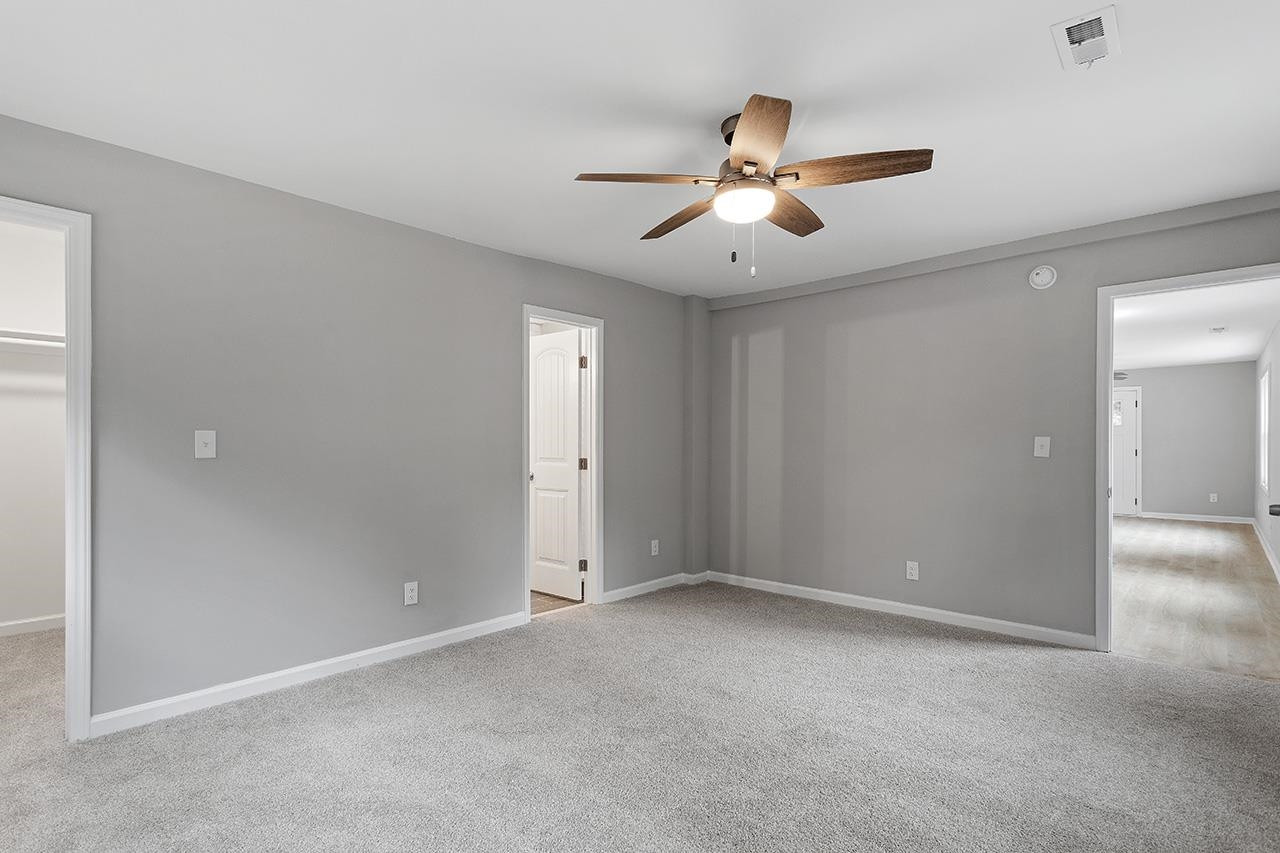 2216 Shannon Street Raleigh, NC 27610 - Photo 23 of 38 an empty room with chandelier fan and windows