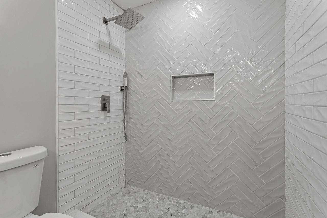 2216 Shannon Street Raleigh, NC 27610 - Photo 29 of 38 a bathroom with a toilet and a shower