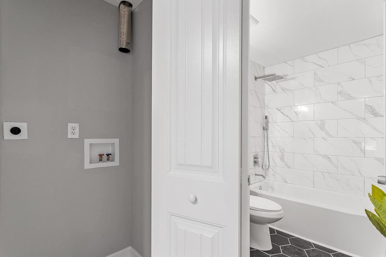 2216 Shannon Street Raleigh, NC 27610 - Photo 31 of 38 a bathroom with a toilet and shower