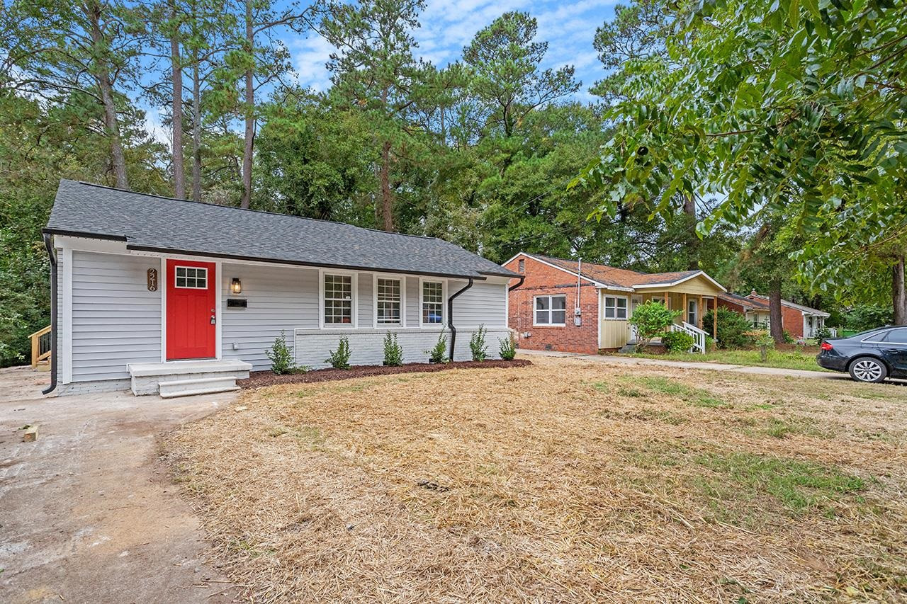 2216 Shannon Street Raleigh, NC 27610 - Photo 32 of 38 a front view of a house with a garden and yard