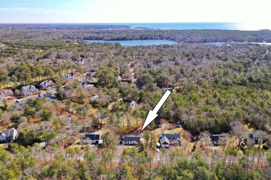 124 Mashpee Neck Road Mashpee, MA 02649 - Photo 1 of 36 an aerial view of a house with a yard