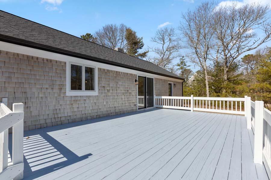 124 Mashpee Neck Road Mashpee, MA 02649 - Photo 12 of 36 a view of a house with wooden deck