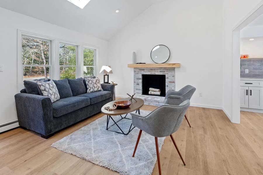 124 Mashpee Neck Road Mashpee, MA 02649 - Photo 8 of 36 a living room with furniture a fireplace and a window