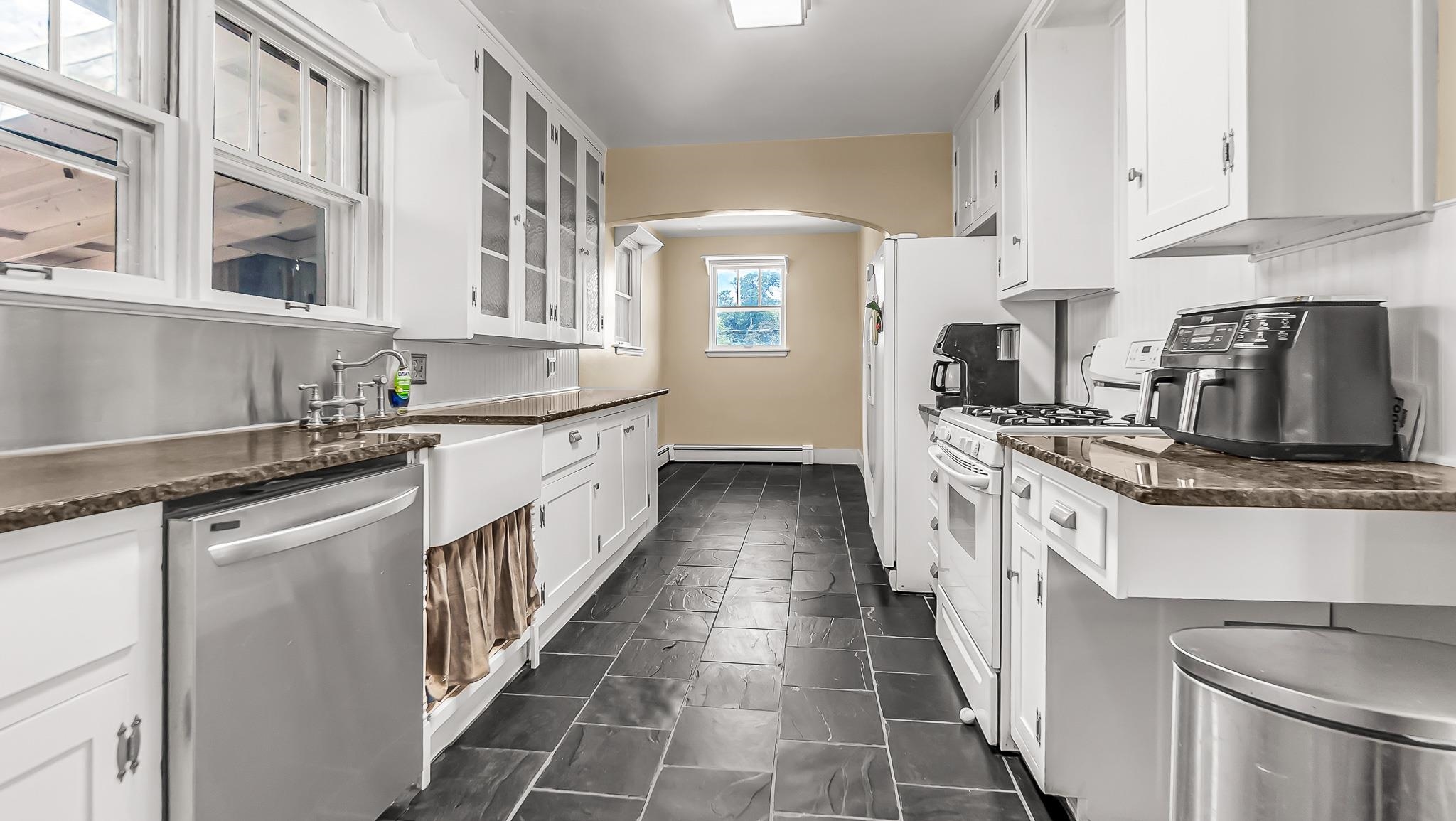 208 3rd Street Parachute, CO 81635 - Photo 7 of 40 a kitchen with stainless steel appliances granite countertop a sink and cabinets
