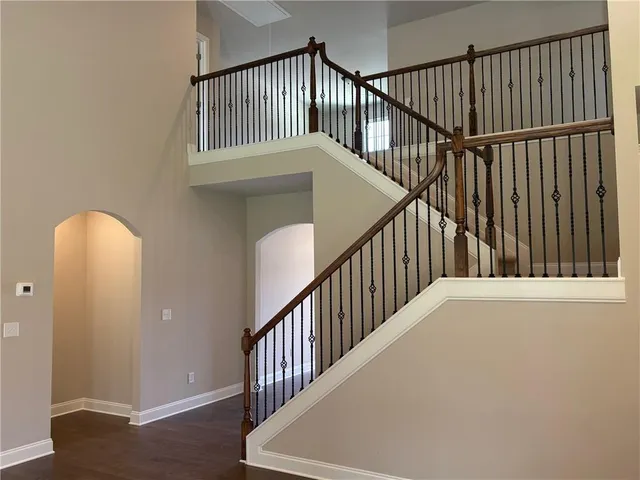 a view of staircase with railing and a window