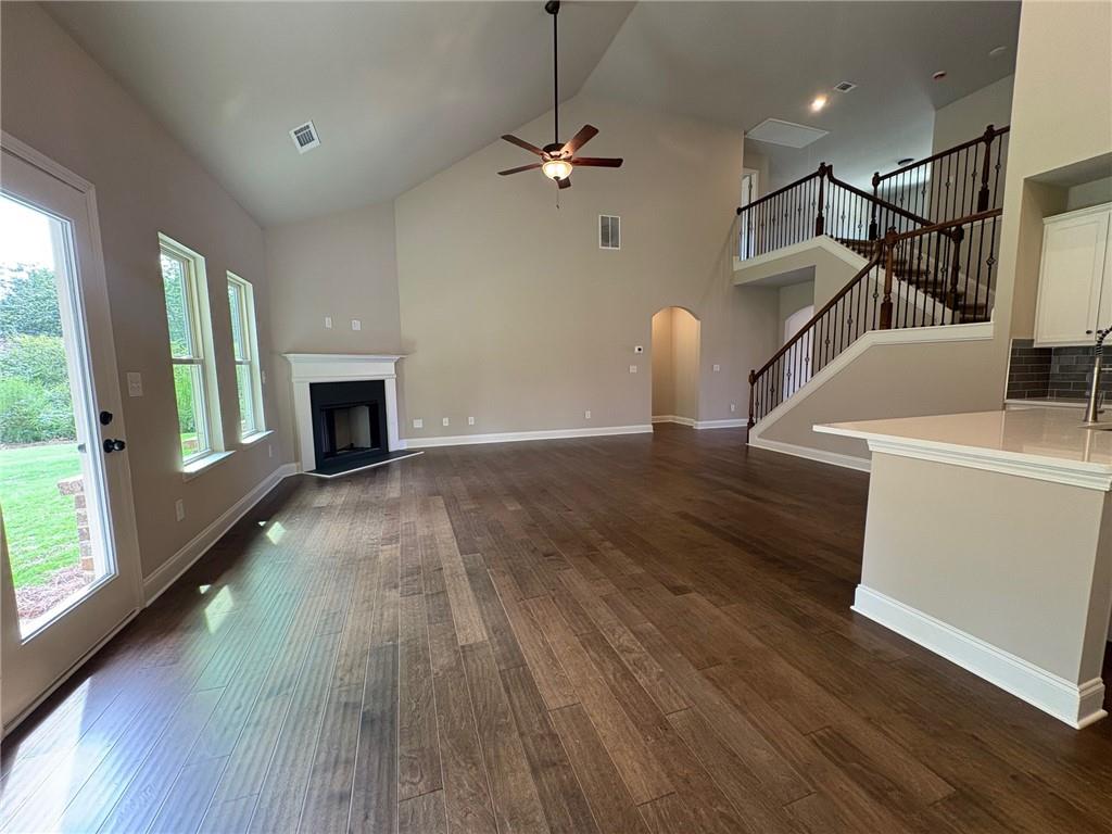 946 Lakeview Oaks Court Grayson, GA 30017 - Photo 13 of 25 a view of a room with wooden floor a ceiling fan and windows