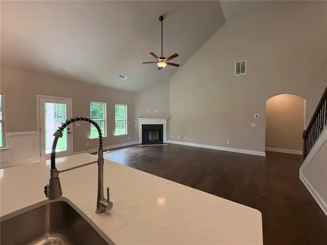 a view of a livingroom with a piano and wooden floor