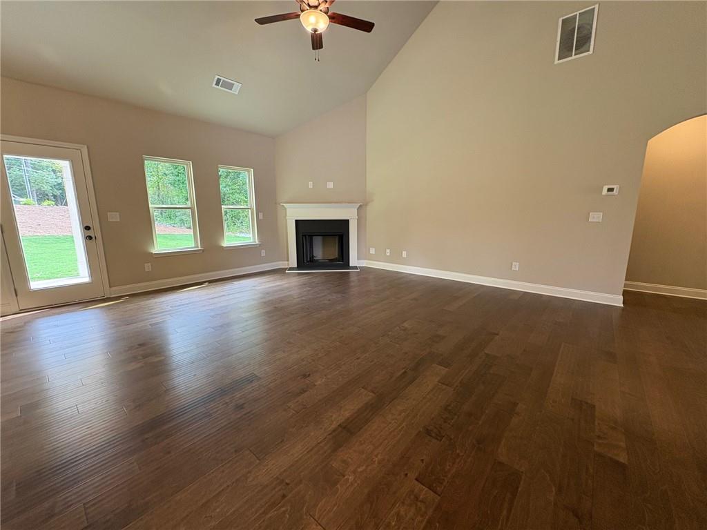 946 Lakeview Oaks Court Grayson, GA 30017 - Photo 17 of 25 an empty room with wooden floor fireplace and windows