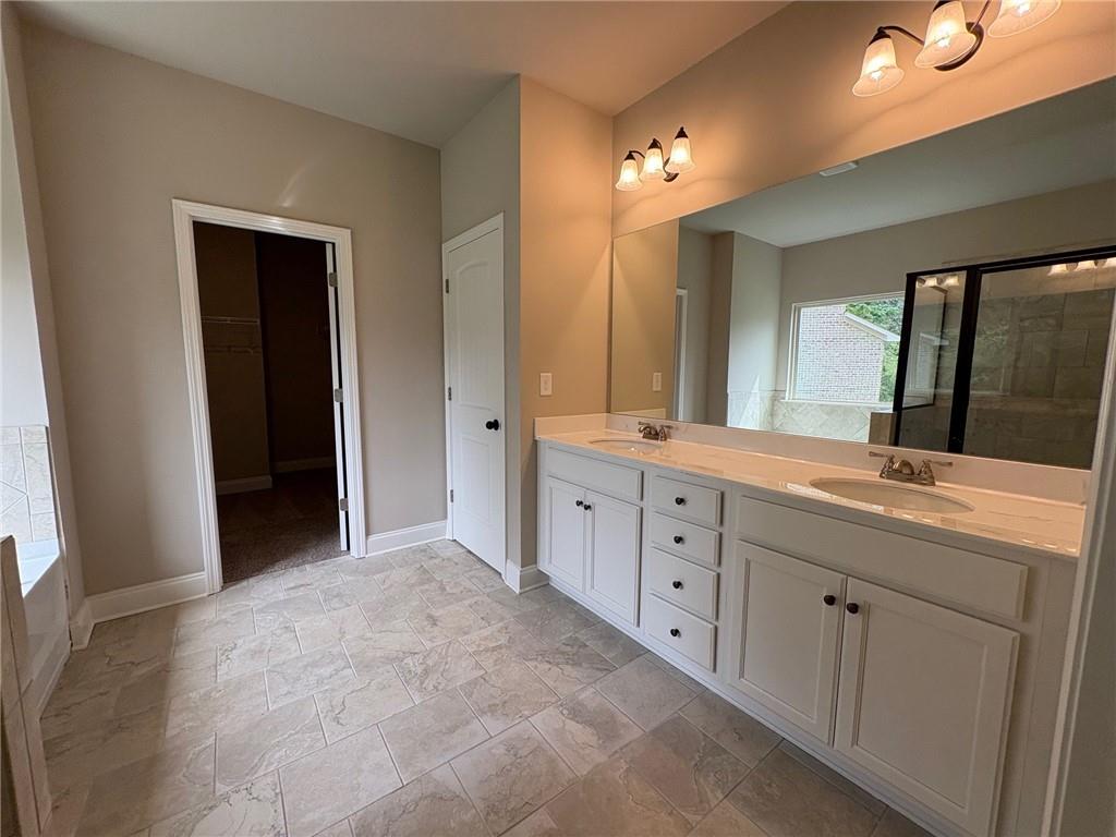 946 Lakeview Oaks Court Grayson, GA 30017 - Photo 19 of 25 a bathroom with a double vanity sink and a mirror