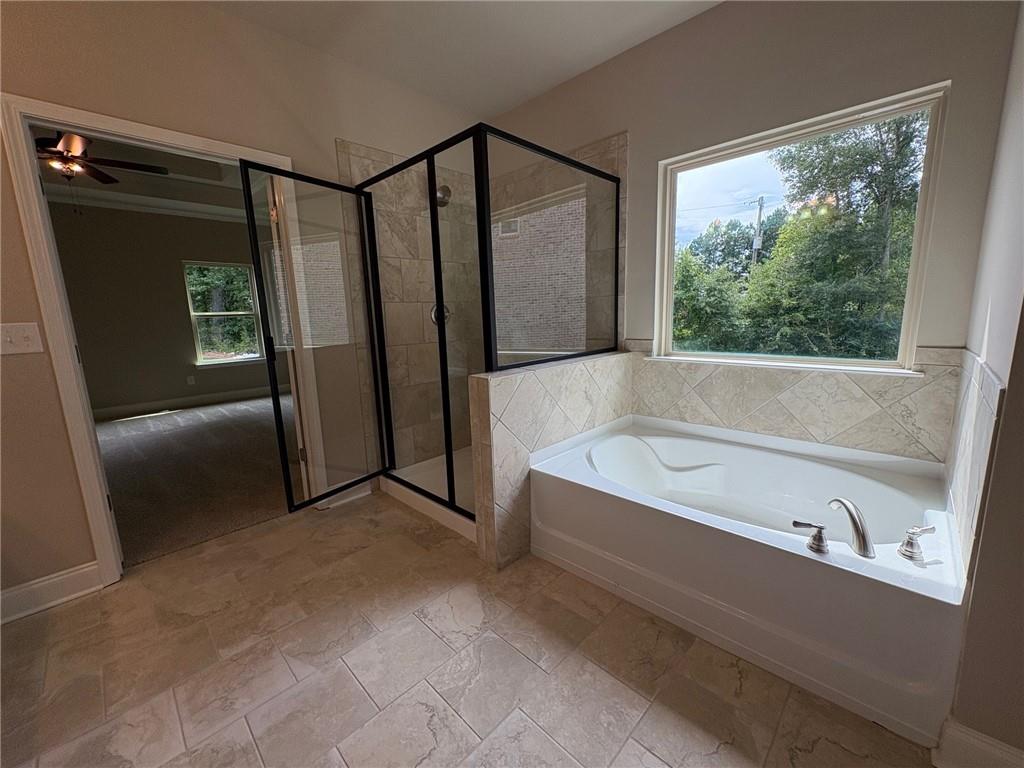 946 Lakeview Oaks Court Grayson, GA 30017 - Photo 20 of 25 a bathroom with a bathtub and a shower