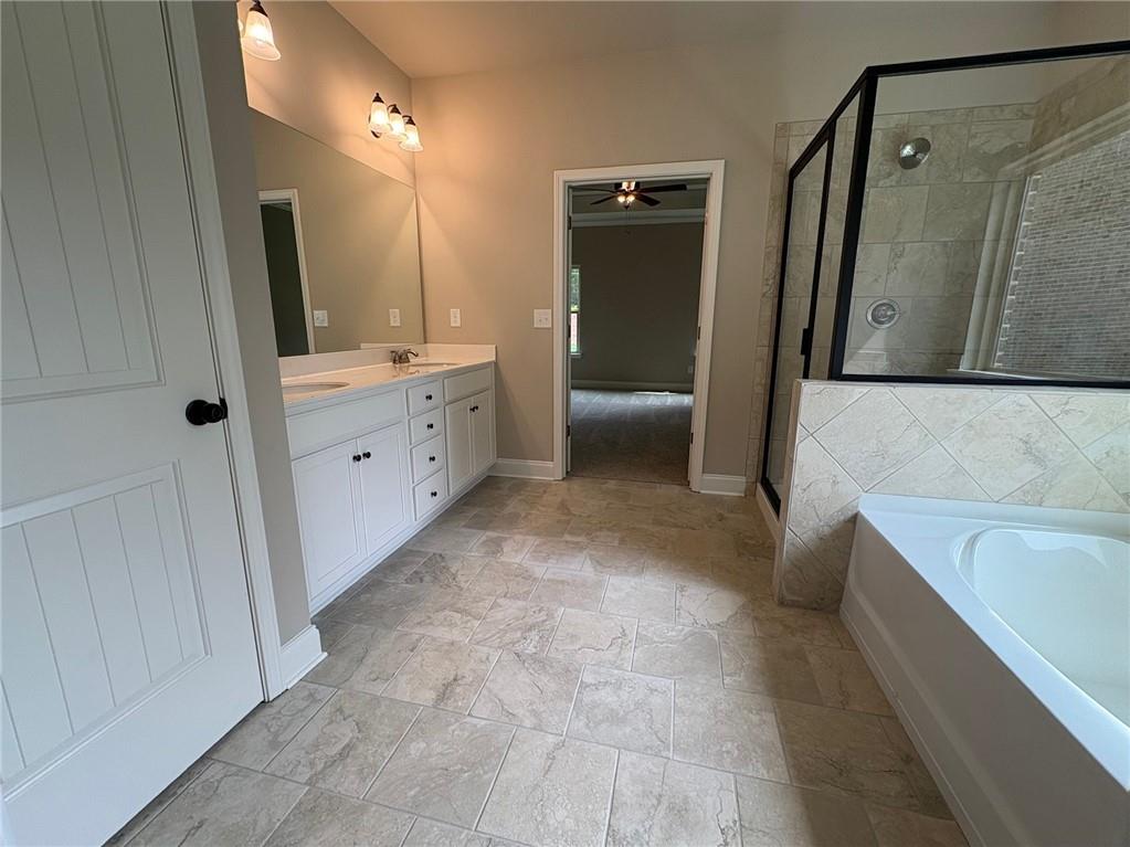 946 Lakeview Oaks Court Grayson, GA 30017 - Photo 21 of 25 a bathroom with a tub sink and mirror