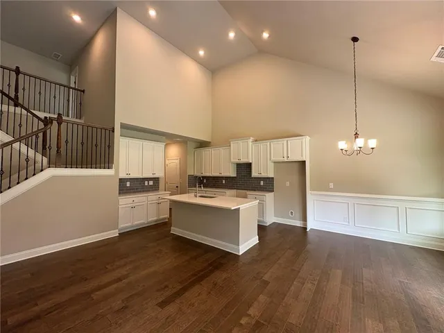 a kitchen with a sink cabinets and wooden floor