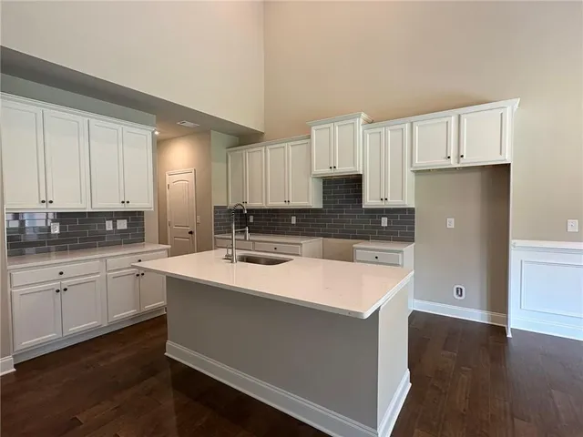 a large kitchen with cabinets appliances