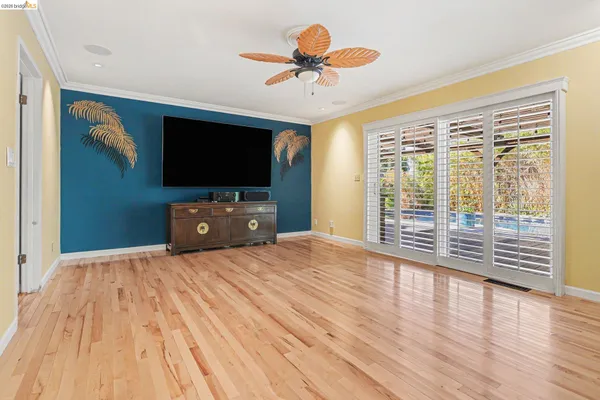 a workspace with wooden floor and a flat screen tv