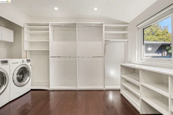 a view of walk in closet with empty racks