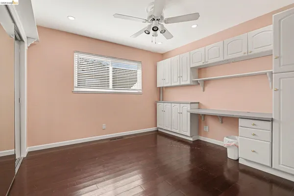 a view of cabinets and window with wooden floor