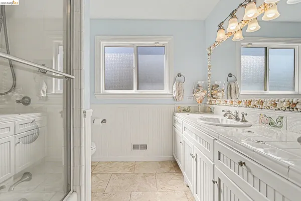 a spacious bathroom with a double vanity sink mirror and double
