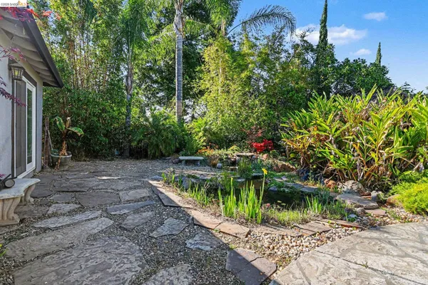 a backyard of a house with a yard and outdoor seating