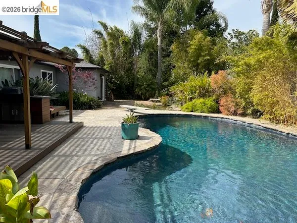 a view of an house with backyard space and balcony