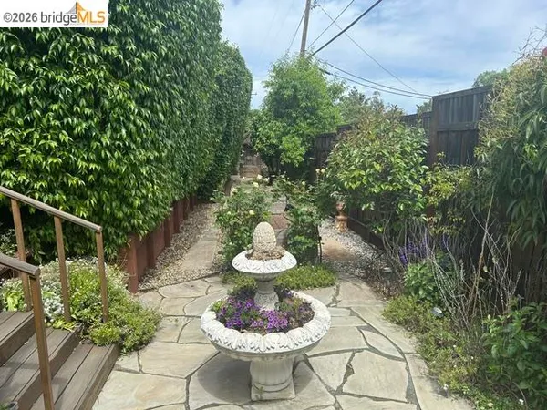 a view of a backyard with plants and a patio