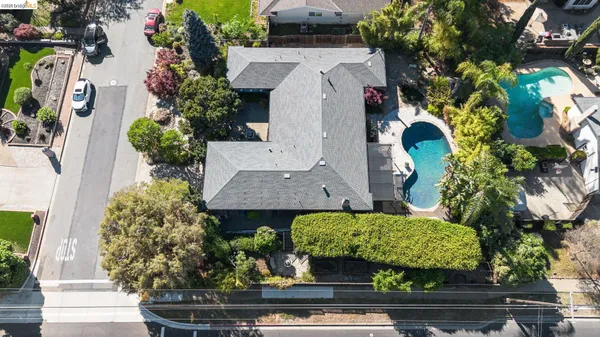 an aerial view of a house with garden space and street view