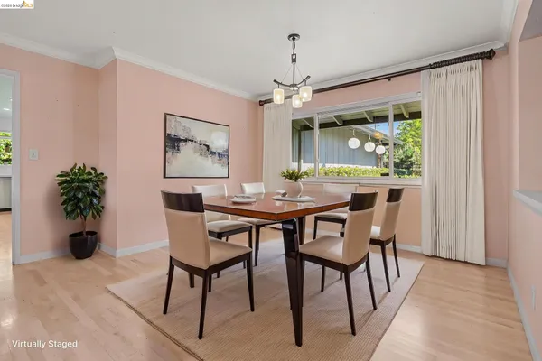 a dining room with furniture potted plants and wooden floor