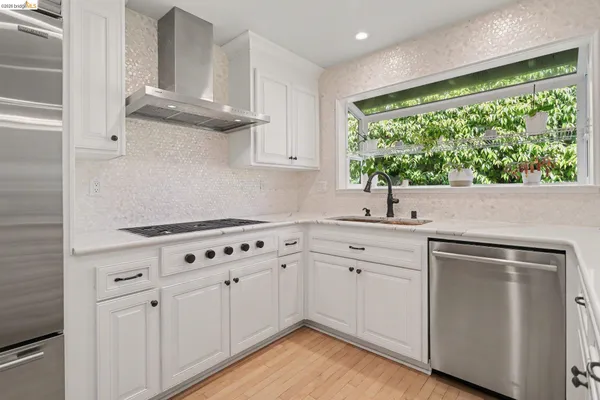 a kitchen with cabinets appliances and a window