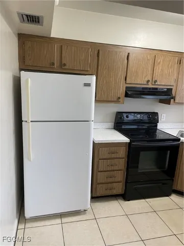 a kitchen with a refrigerator and a stove