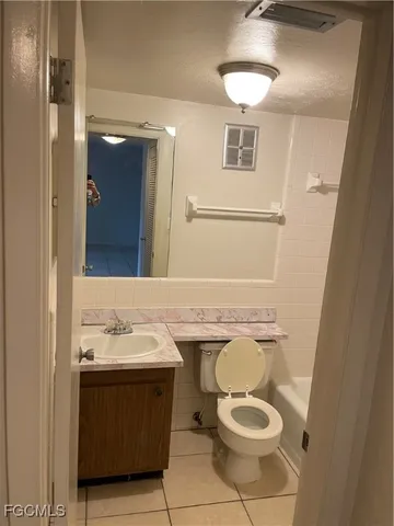 a bathroom with a sink toilet and mirror