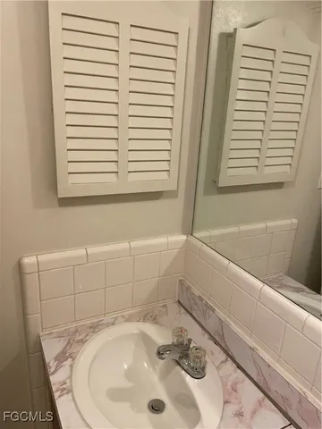 a bathroom with a sink and a window