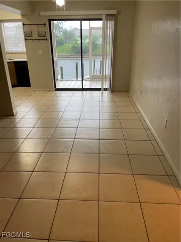 a view of a livingroom with an empty space and a window