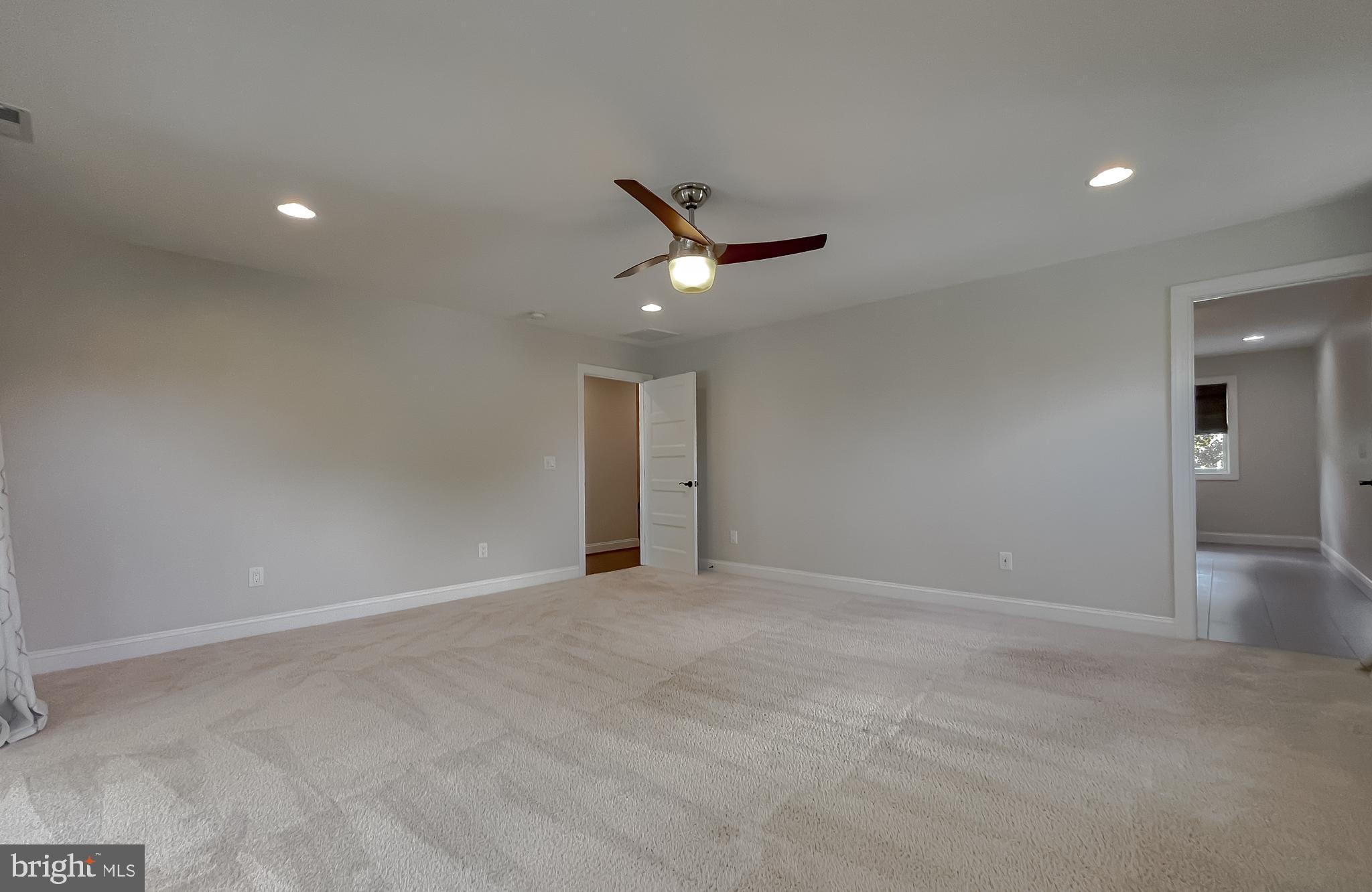 24754 Half Pone Point Road Hollywood, MD 20636 - Photo 105 of 137 a view of an empty room with a ceiling fan