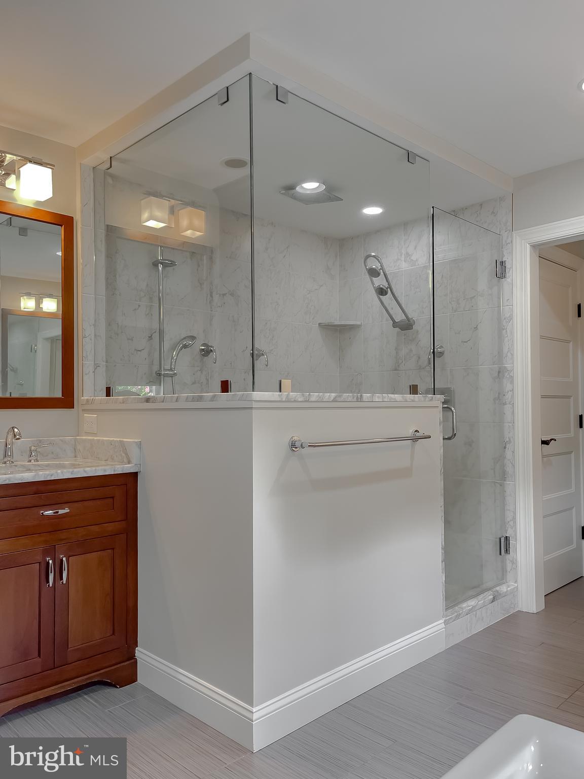 24754 Half Pone Point Road Hollywood, MD 20636 - Photo 111 of 137 a bathroom with a sink a toilet a large mirror and shower