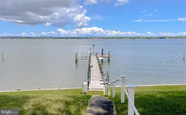 an empty room with a ceiling fan and a window
