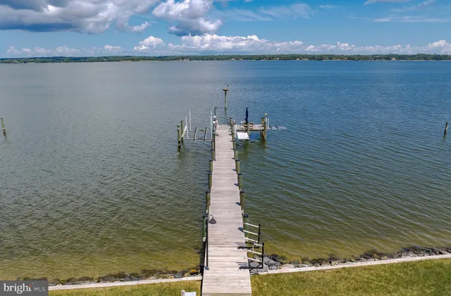 a view of a room that has a window and a bed